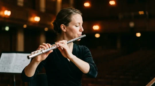 Professional flutist in performance posture demonstrating proper breath support technique