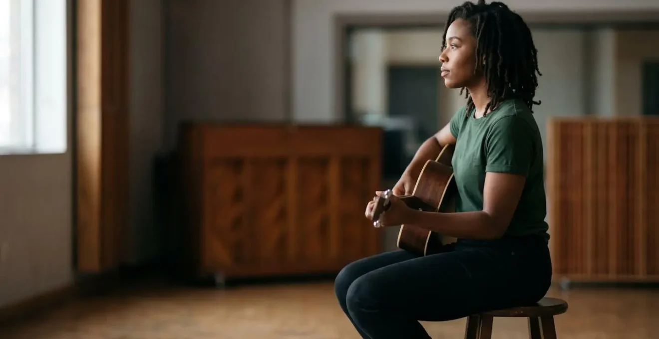 A musician seated with exemplary posture showing proper core engagement, photographed in natural light with environmental context
