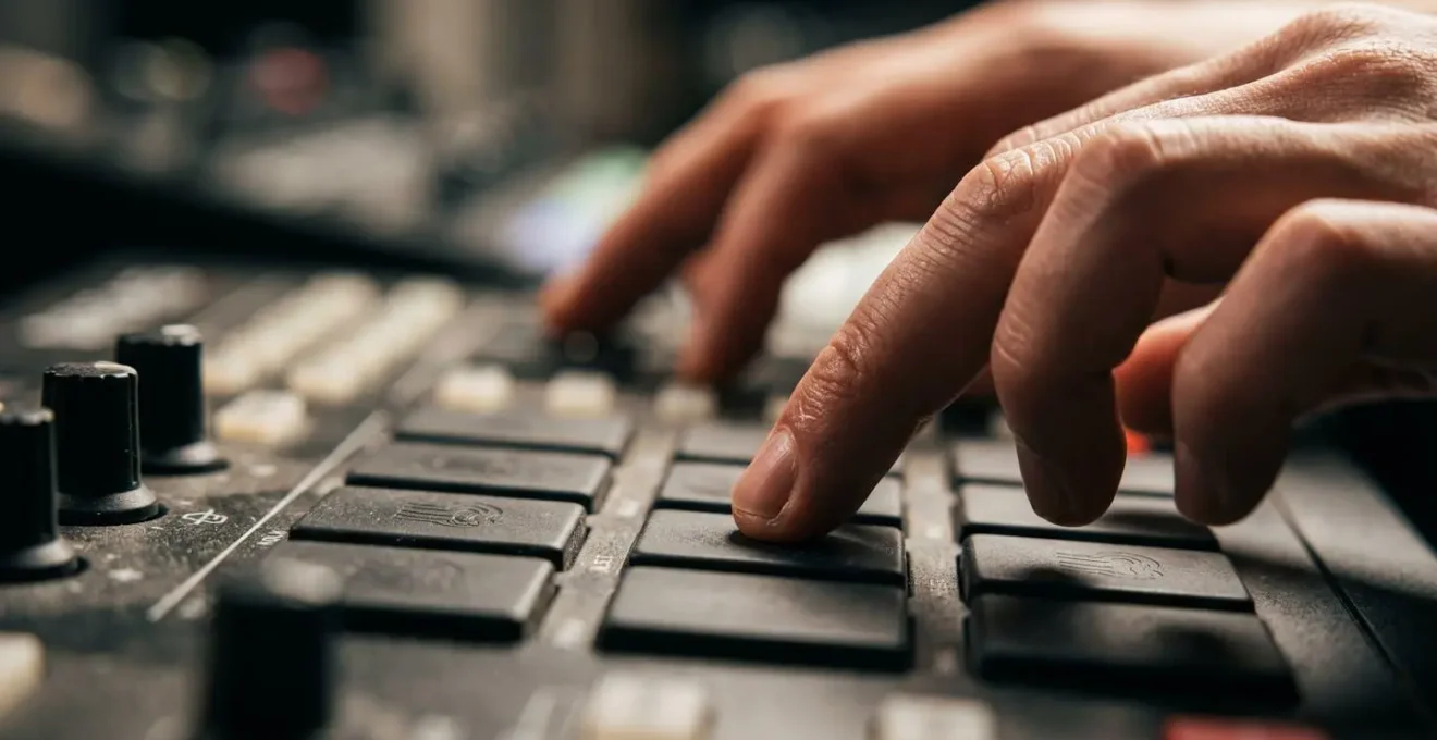 Close-up macro view of music producer's hands manipulating timing controls for humanized groove