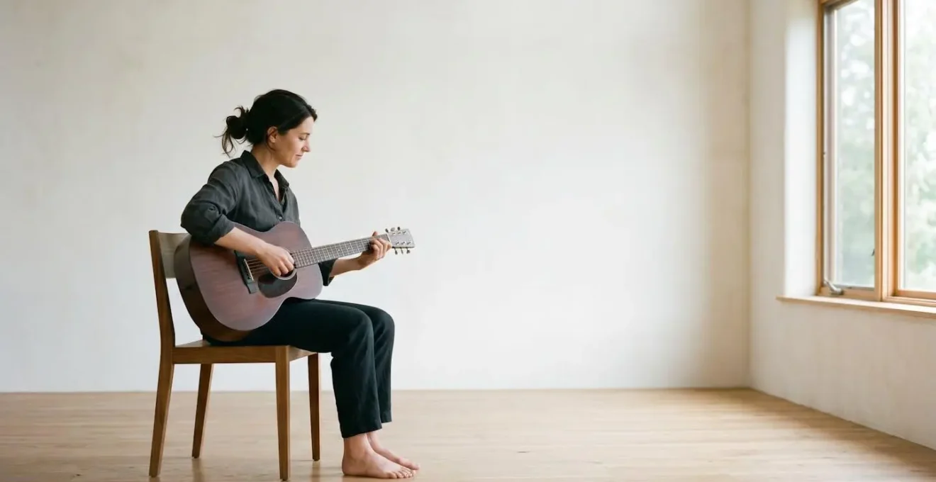 Wide environmental shot of musician in correct upright posture showing open chest and relaxed shoulders in minimalist practice space